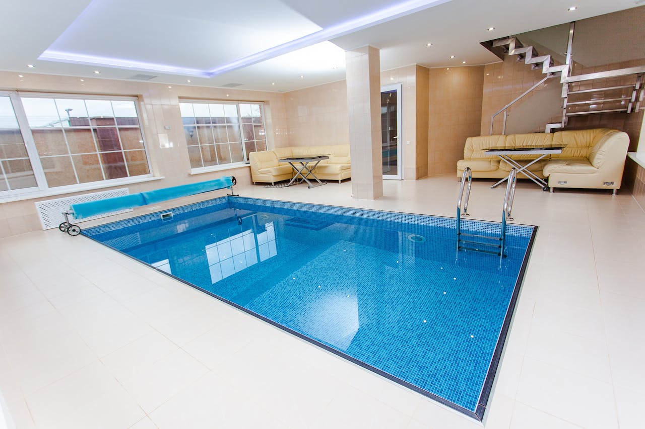 about-img-01 Luxurious indoor pool area featuring modern design and elegant furnishings.